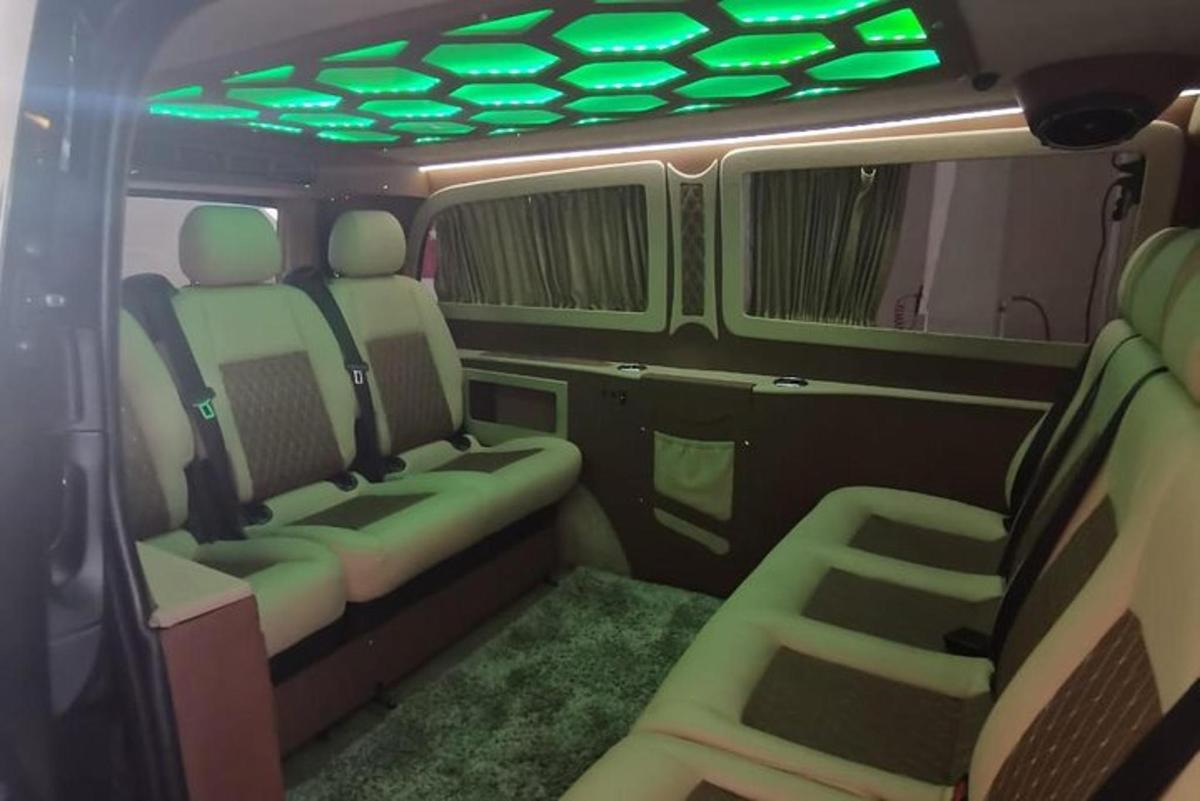 an inside view of a van with green lights