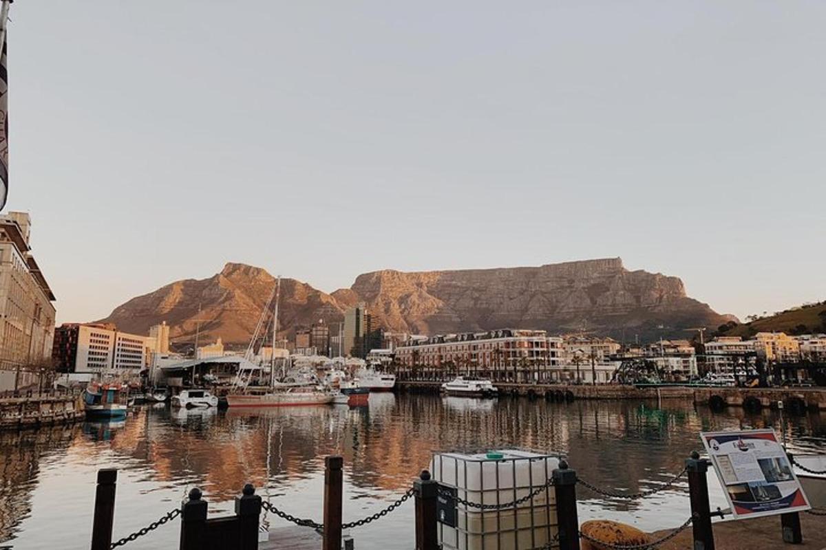 a harbor with boats in the water with a mountain in the background