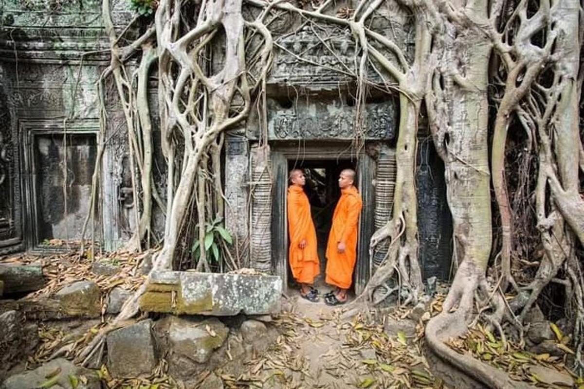 due monaci in abiti arancioni in piedi su una porta