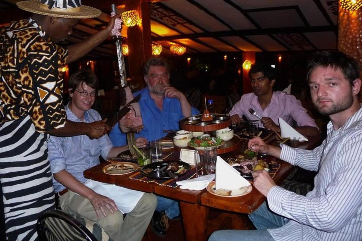 a group of men sitting around a table eating food