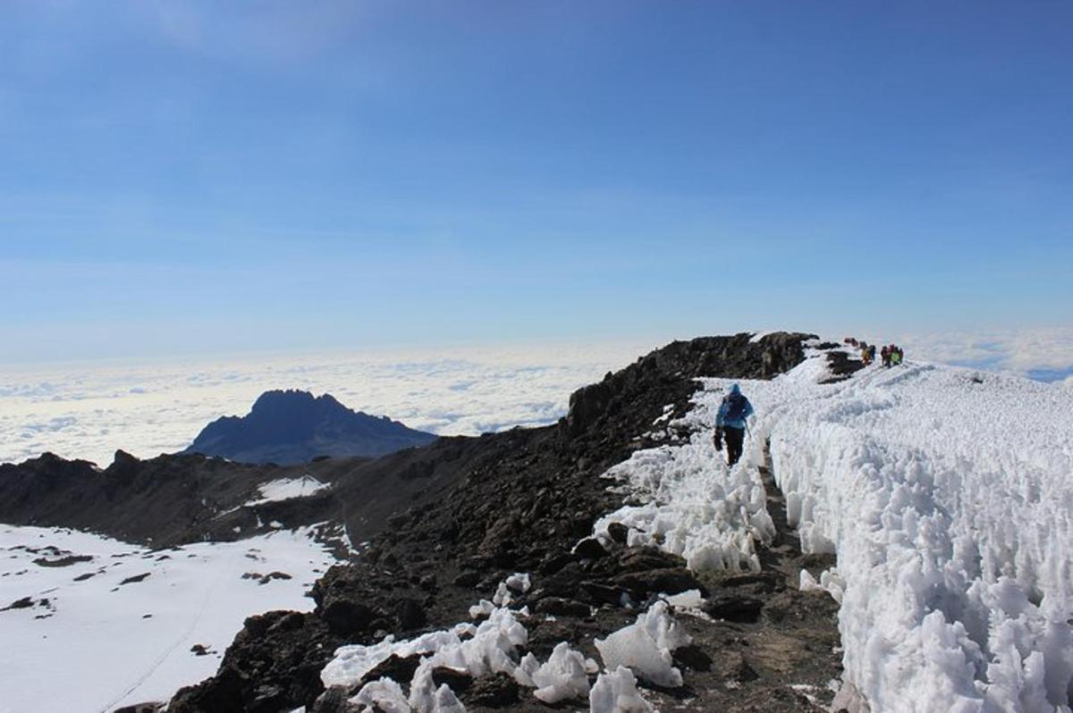 a person walking on a mountain covered in snow