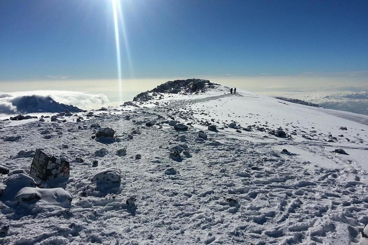 a group of people on top of a snow covered mountain