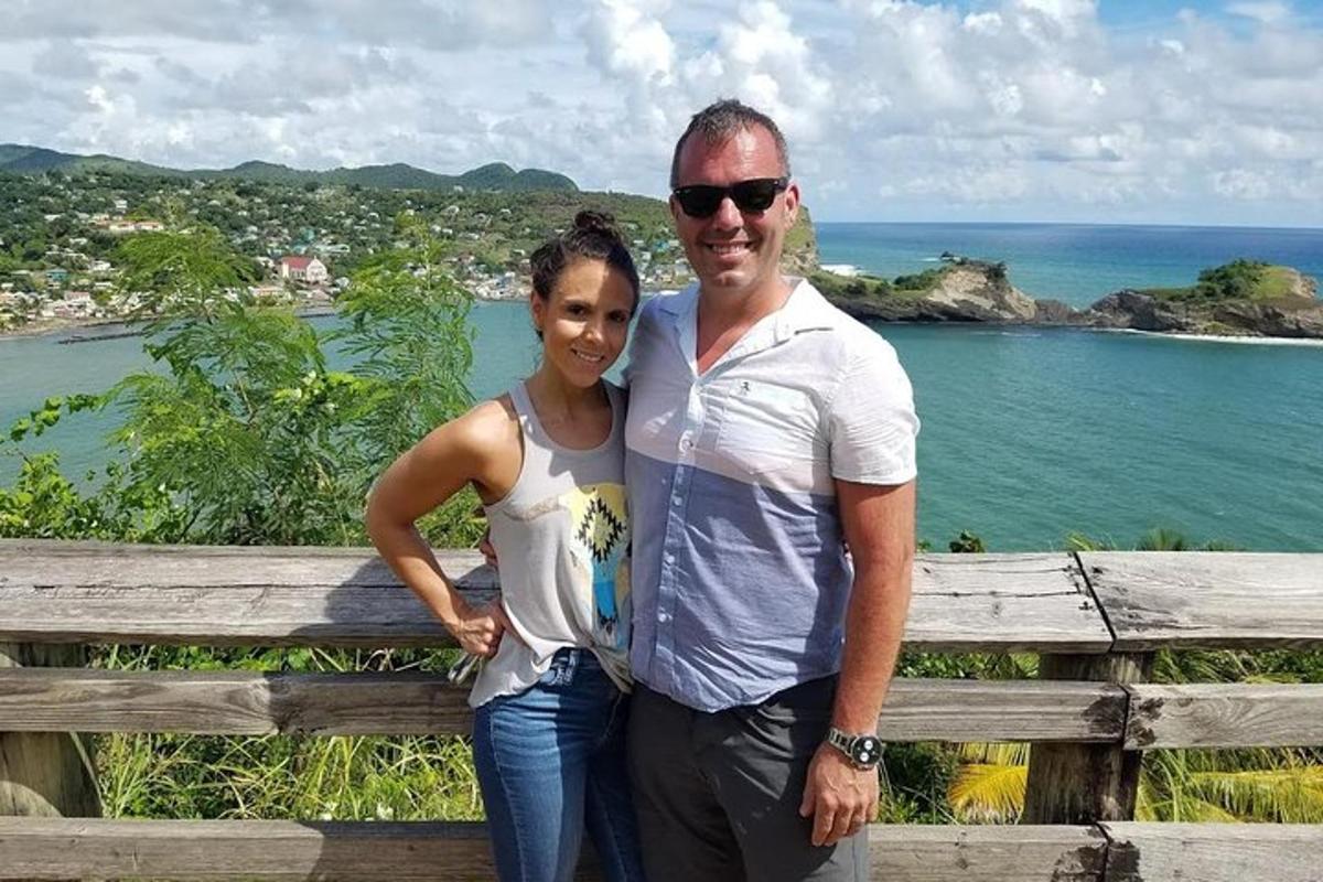 a man and a woman standing in front of the ocean