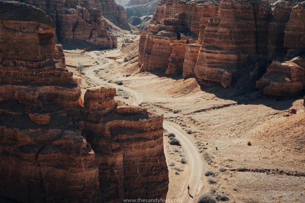 a winding road in a canyon in the desert