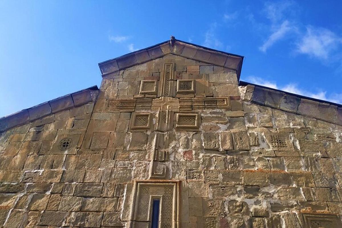 an old stone building with a window on the top