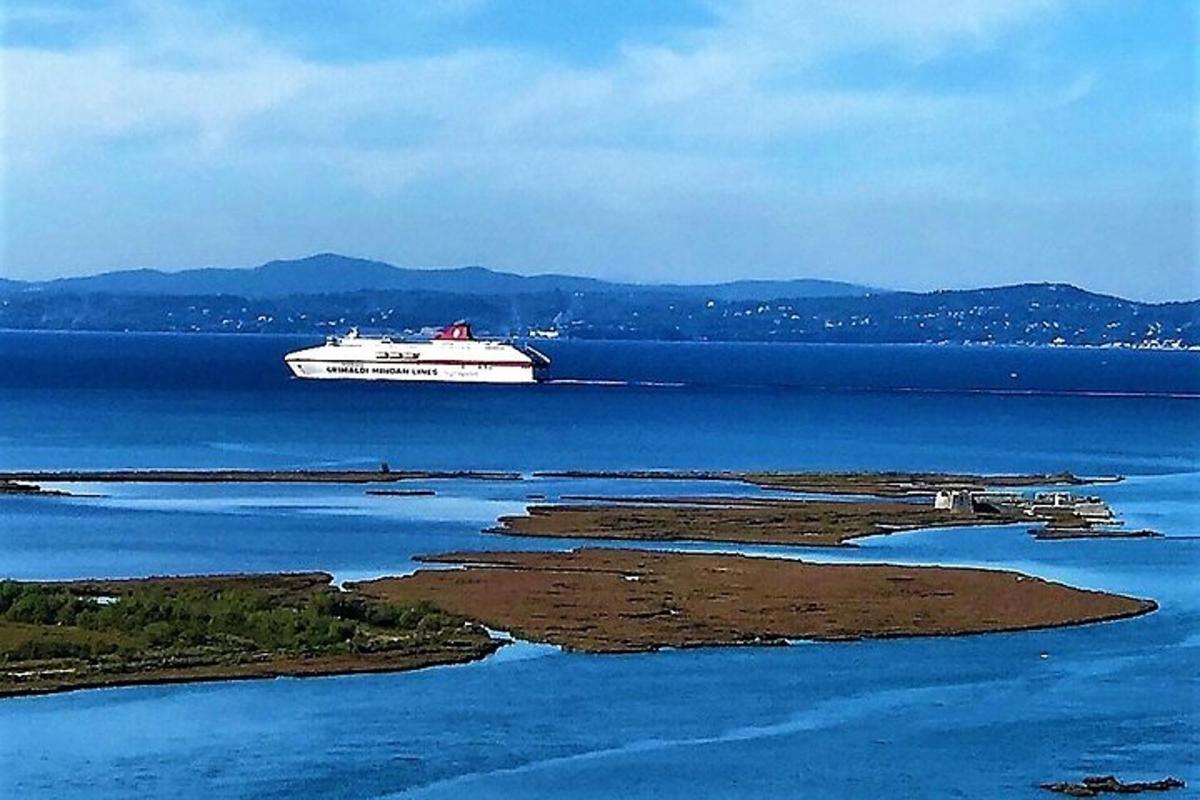a cruise ship on the water with a island