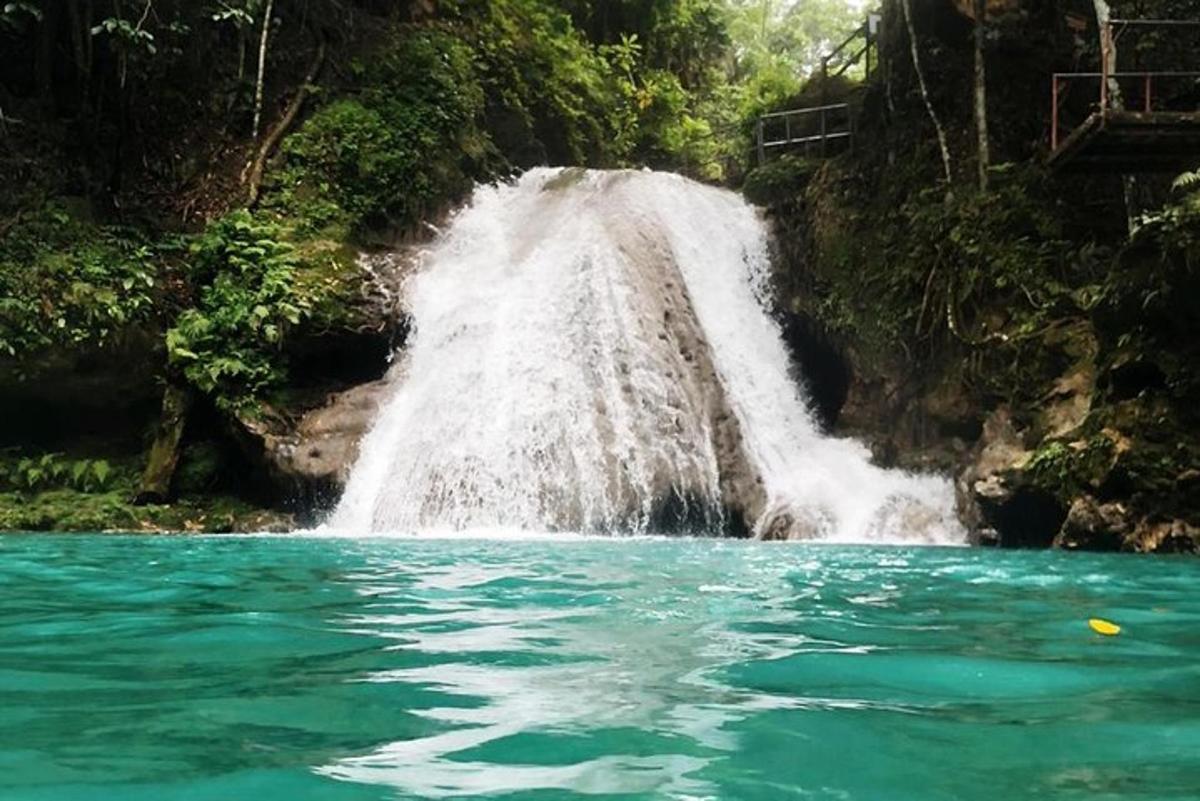 a waterfall in the middle of a body of water