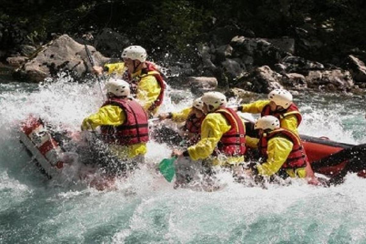 a group of people in a raft in the water