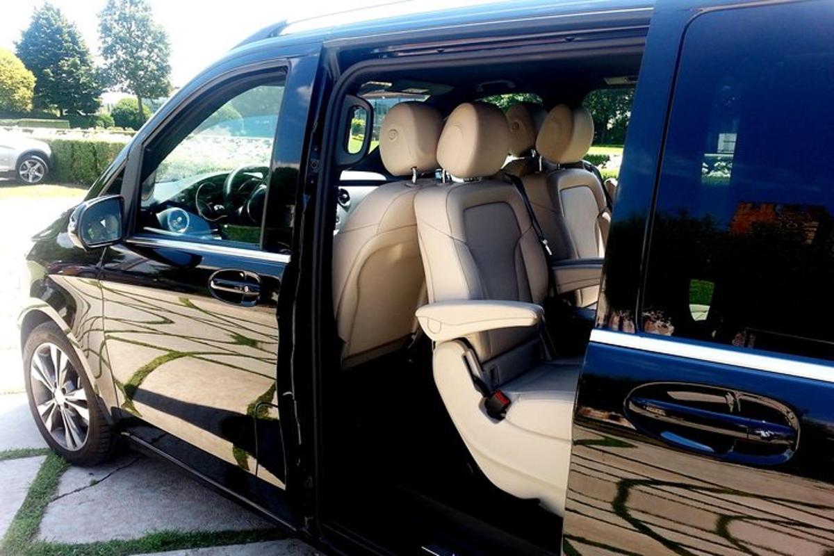 a blue van with the doors open with the back seats