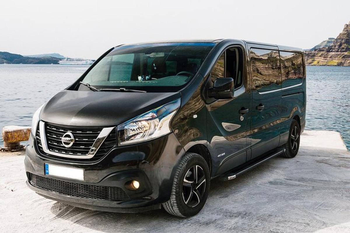 a black van parked next to a body of water