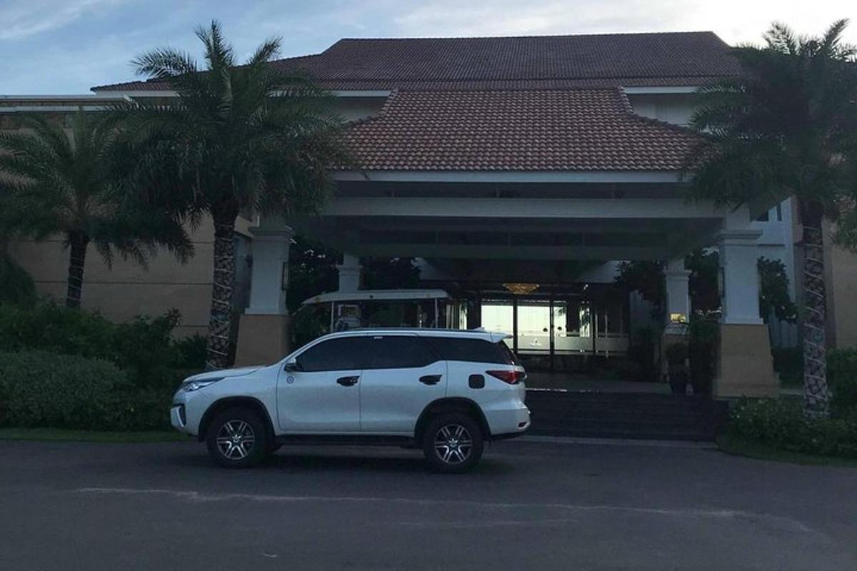 a white car parked in front of a house