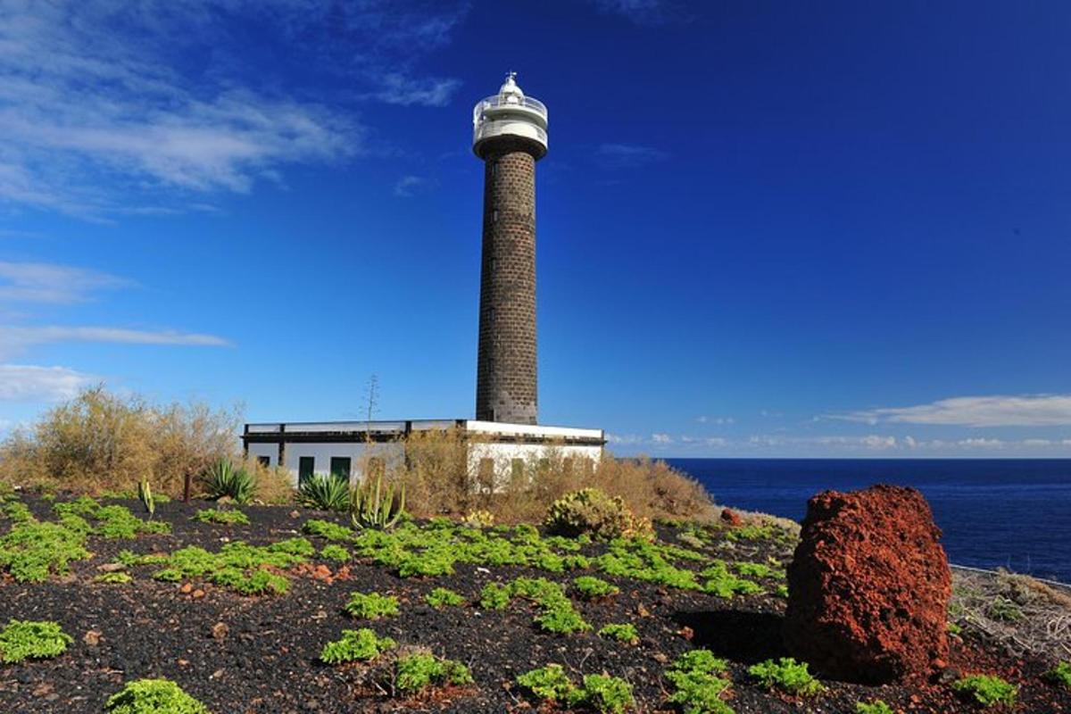 a lighthouse sitting on the side of the ocean