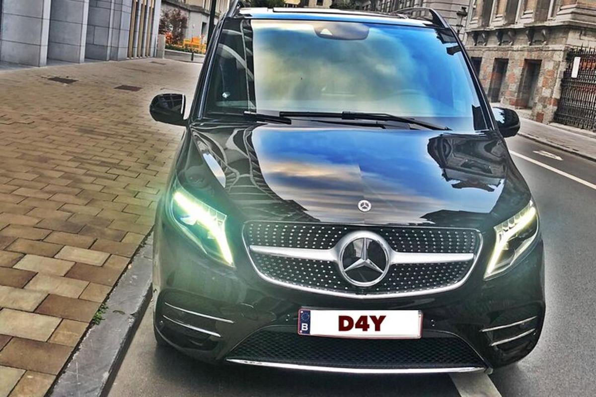 a green car parked on the side of a street