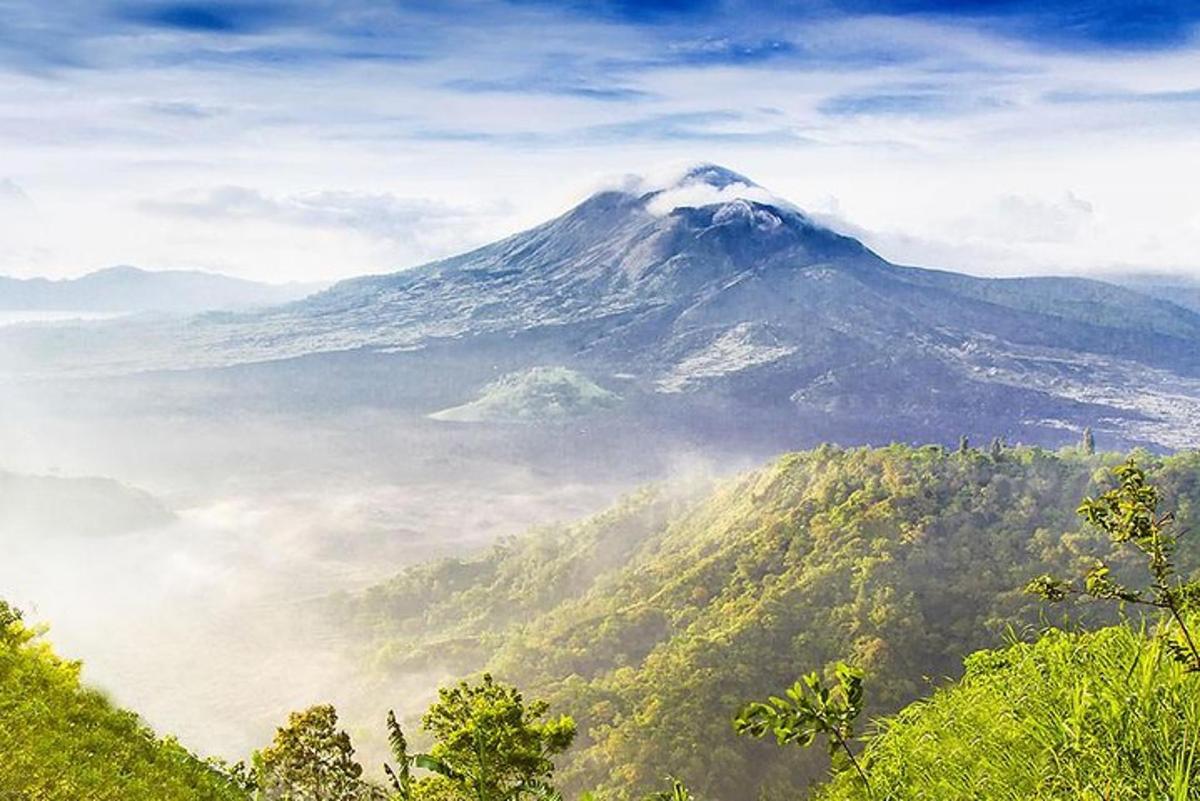 una vista di una montagna con la nebbia di fronte