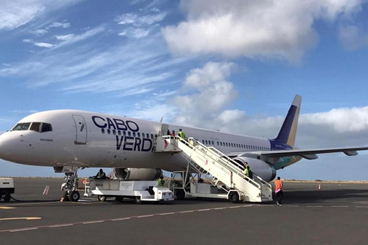 a group of people boarding an airplane on the runway