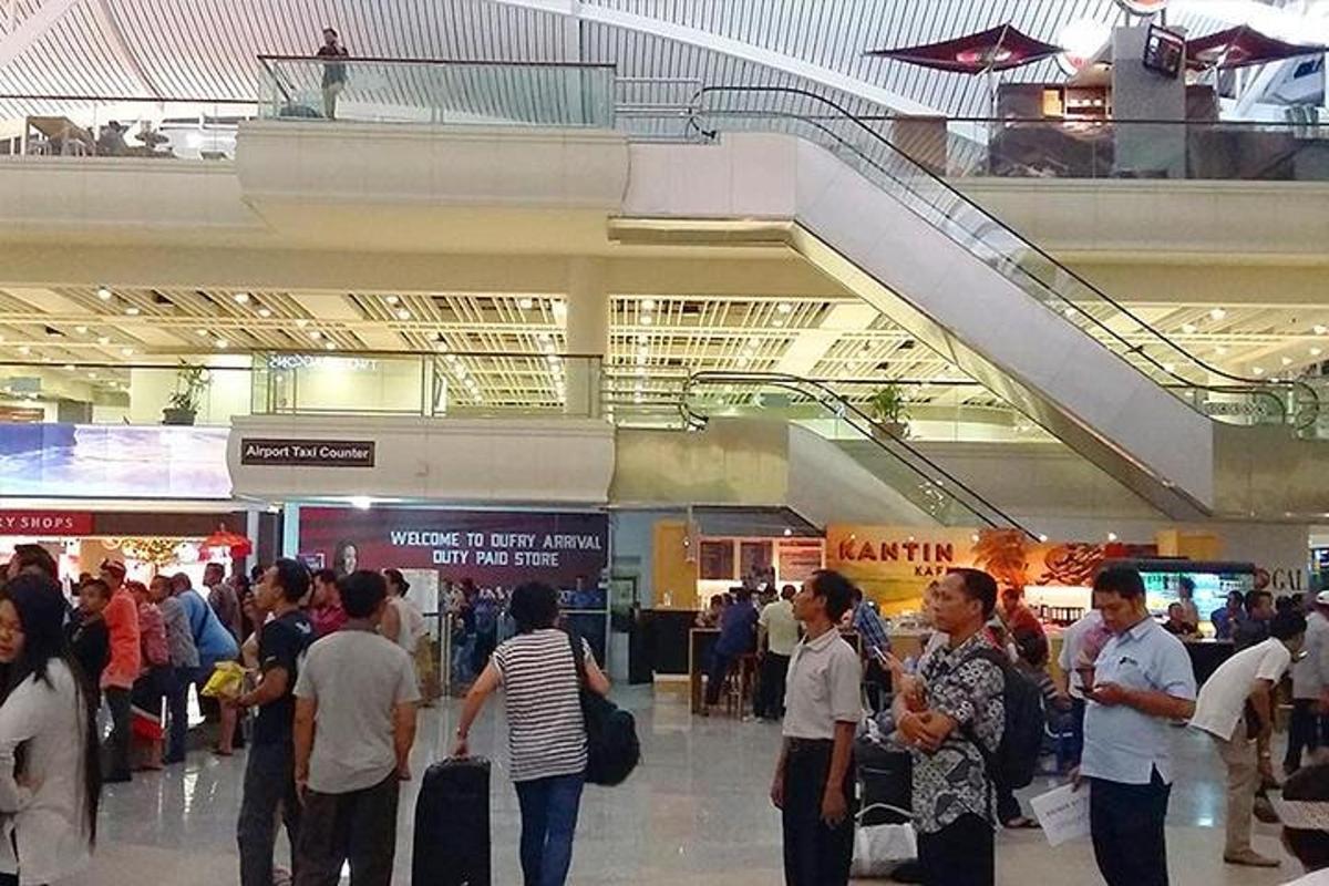 a crowd of people standing in an airport