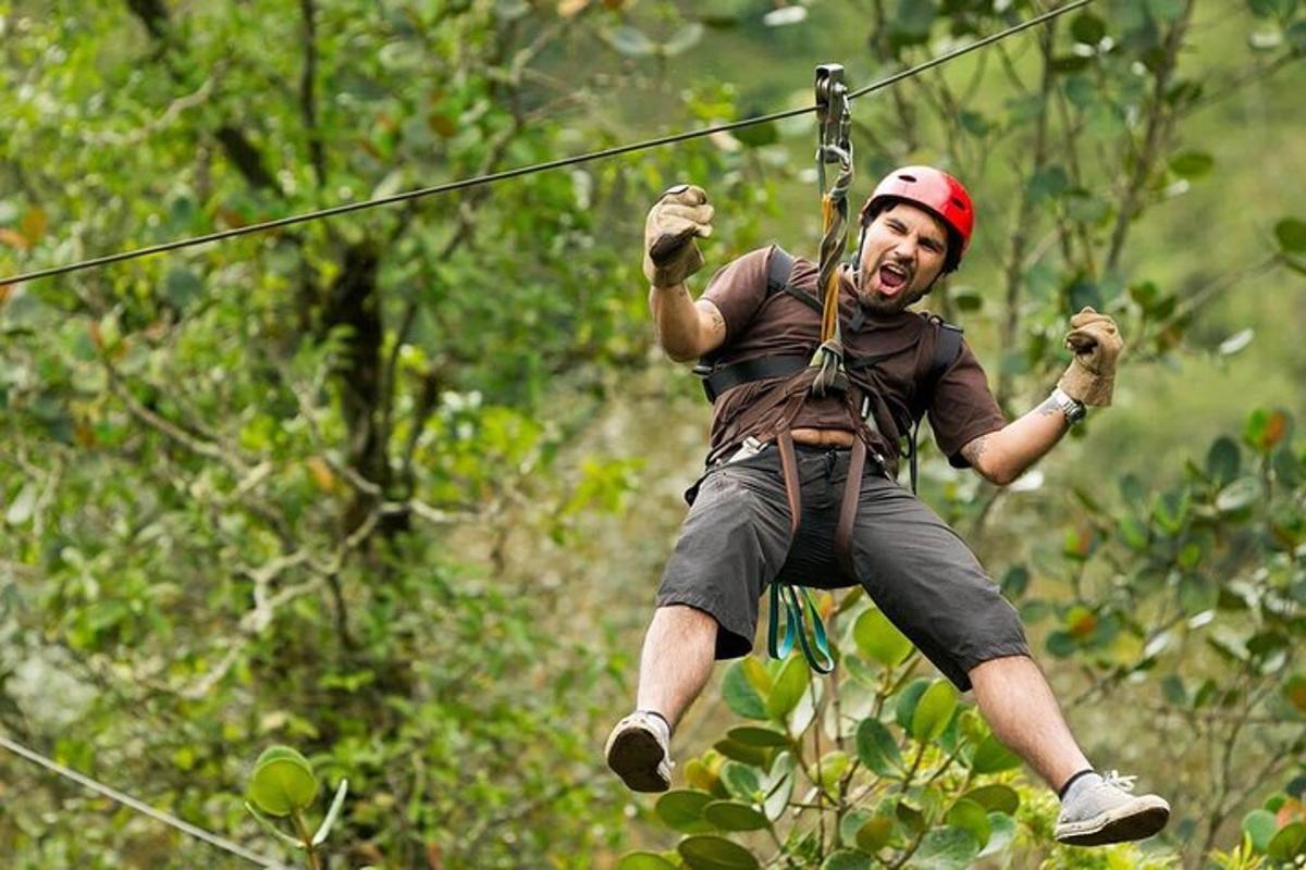 a man suspended in the air on a zip line