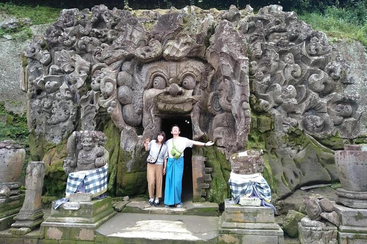a man and a woman standing in front of a statue
