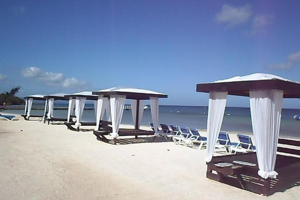 a row of tables and chairs on a beach