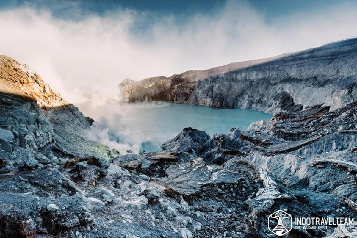 a view of a blue pool of water on a mountain