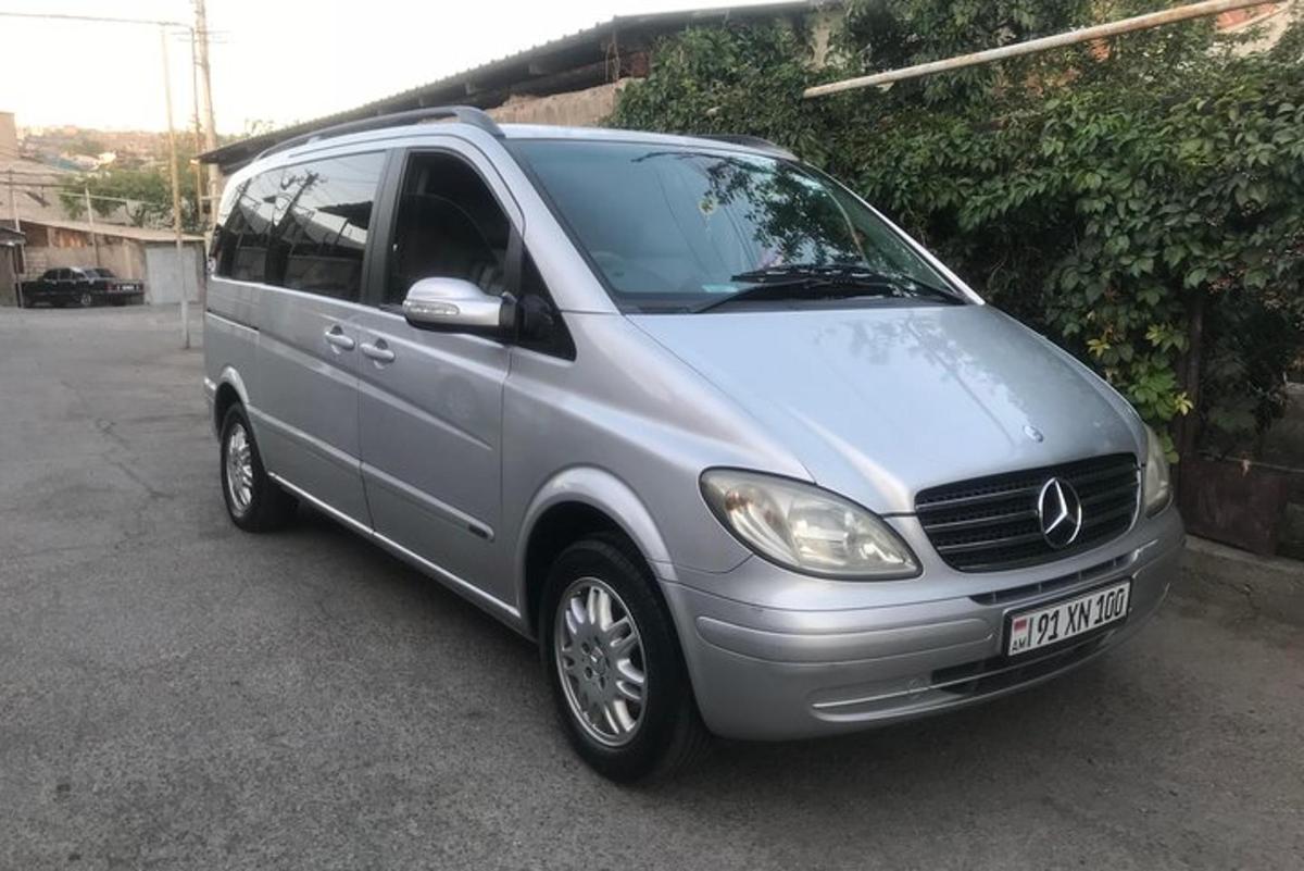 a silver van parked in a parking lot
