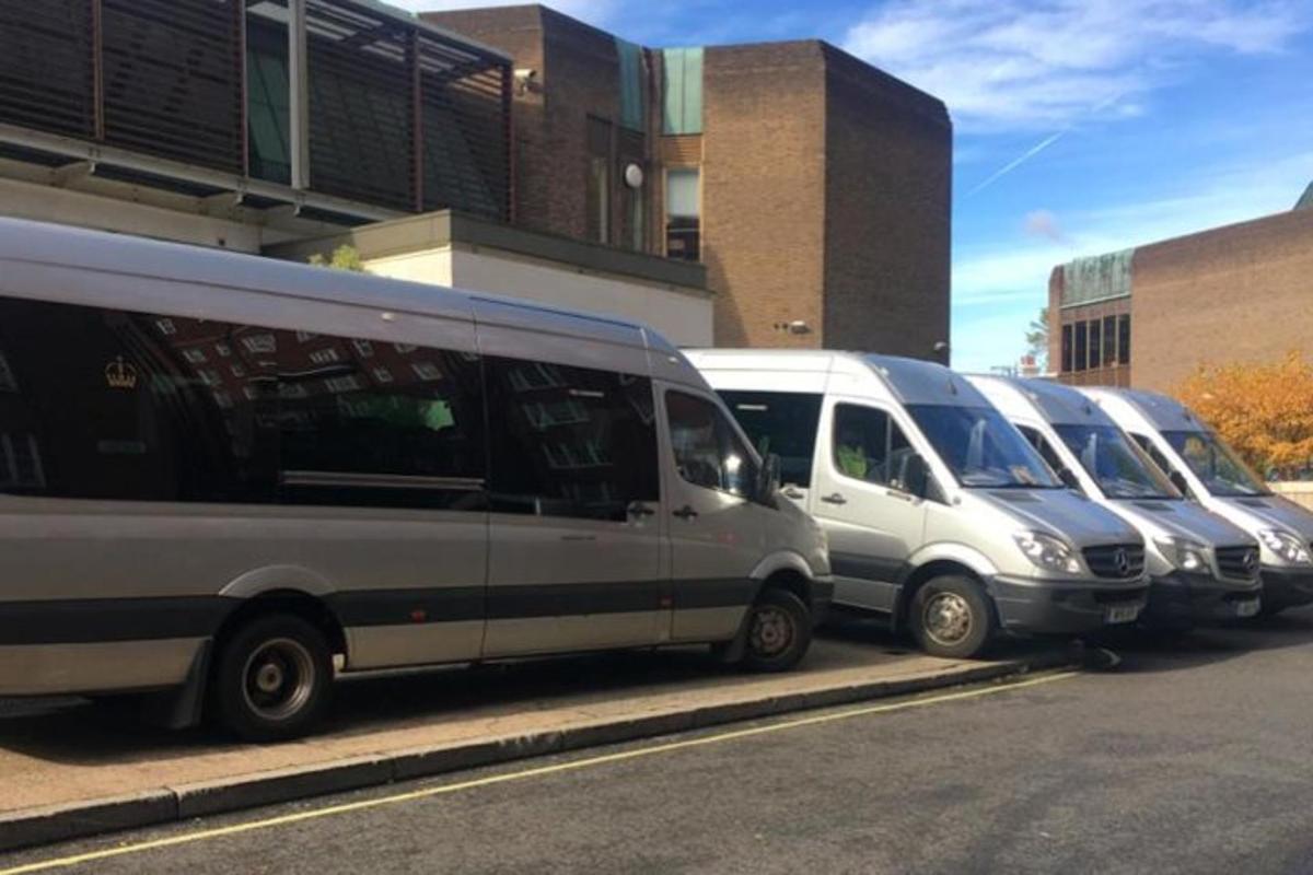 a row of parked buses parked in front of a building