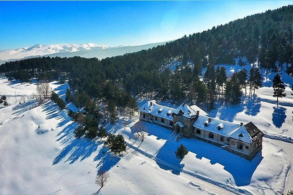 an aerial view of a house in the snow