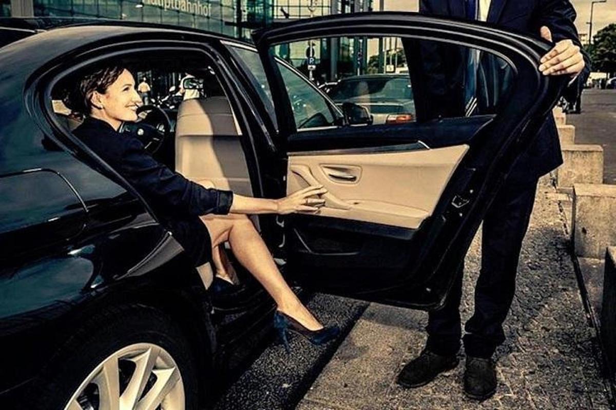 a man and a woman sitting in a car