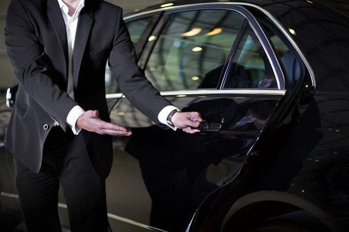 a man in a suit getting out of a car