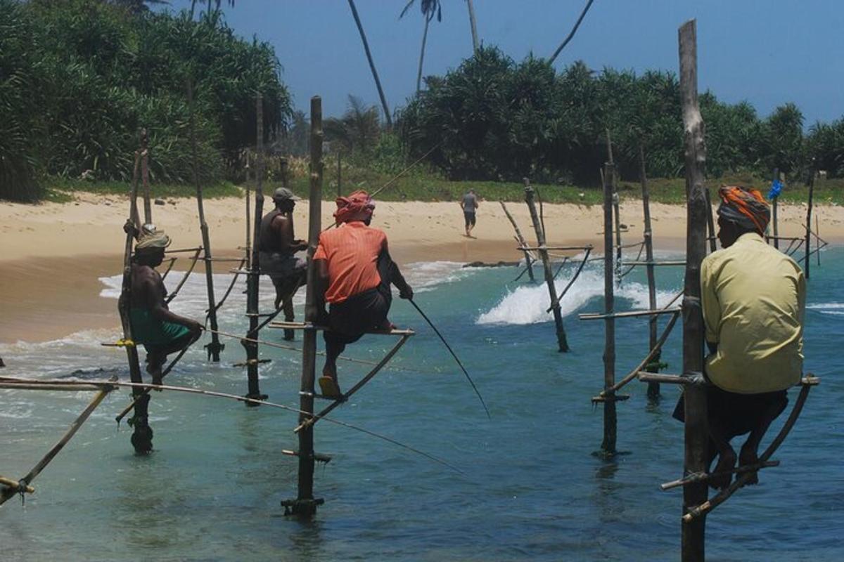 a group of people crossing a bridge over the water