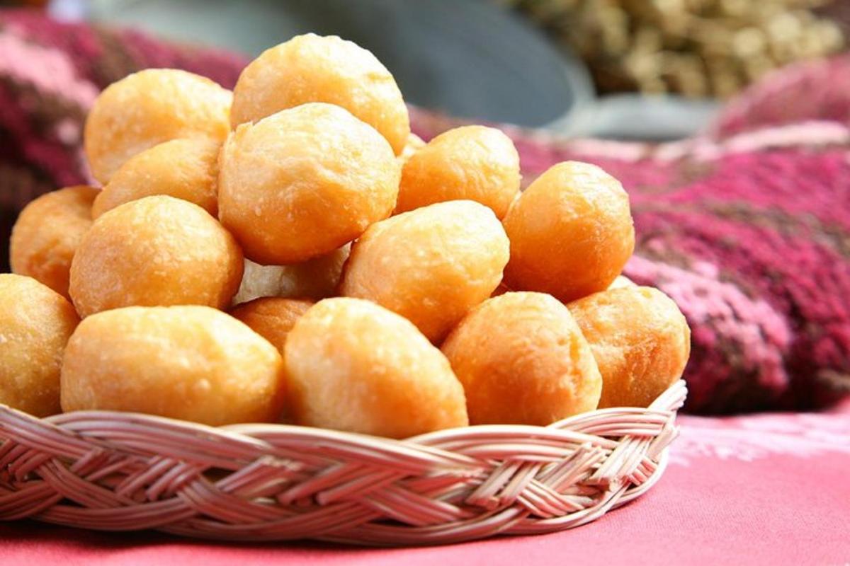 a pile of donuts in a basket on a table