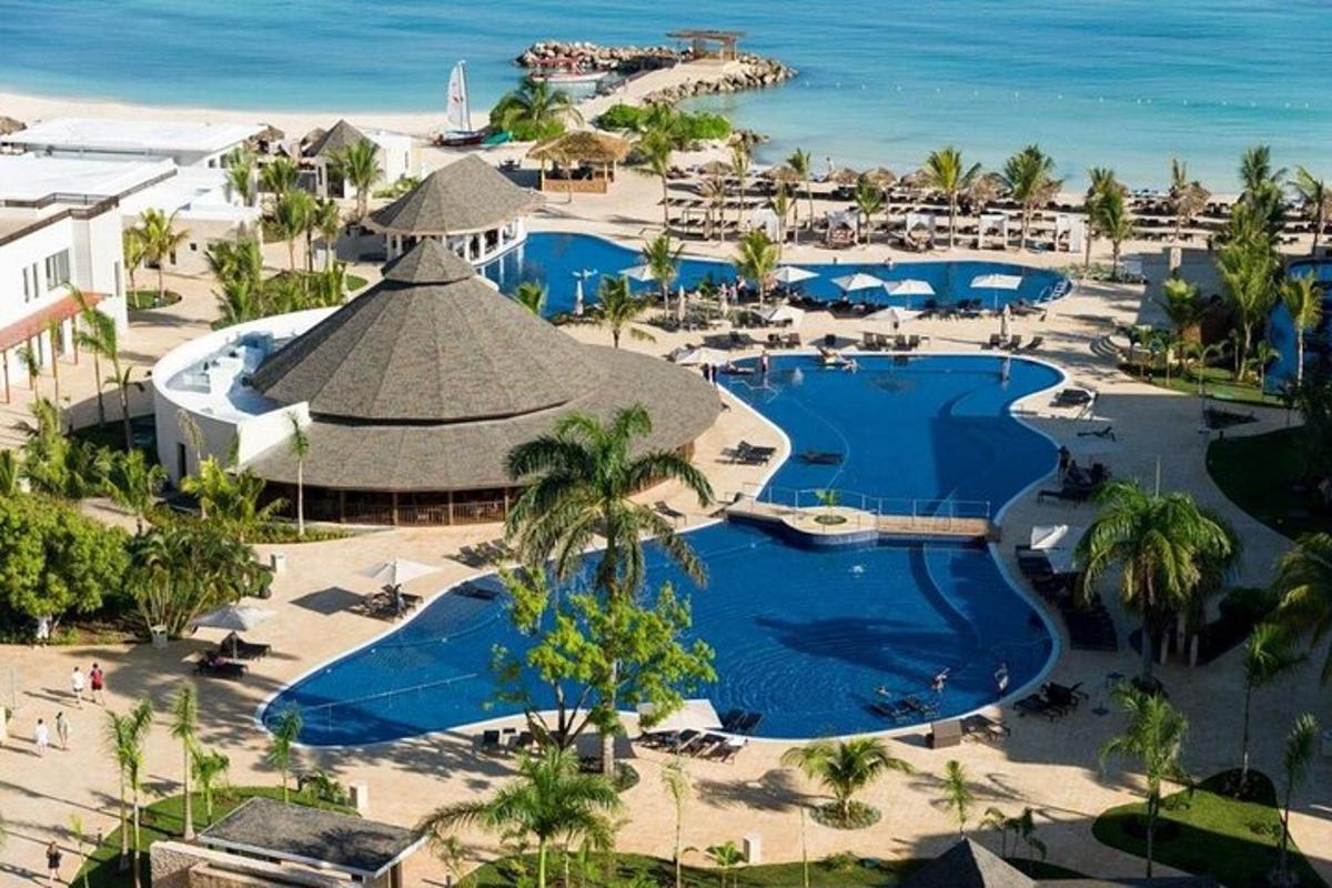 an aerial view of a resort with two pools