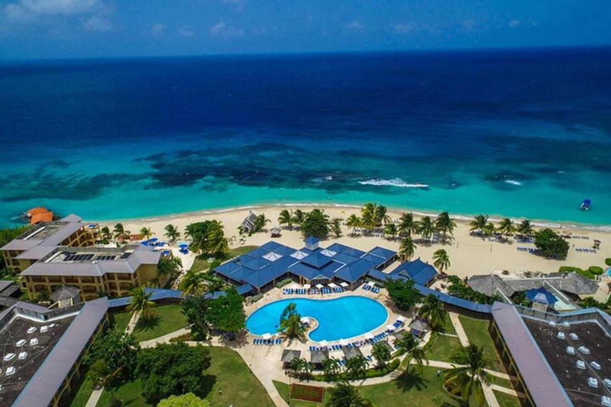 an aerial view of the resort and the beach