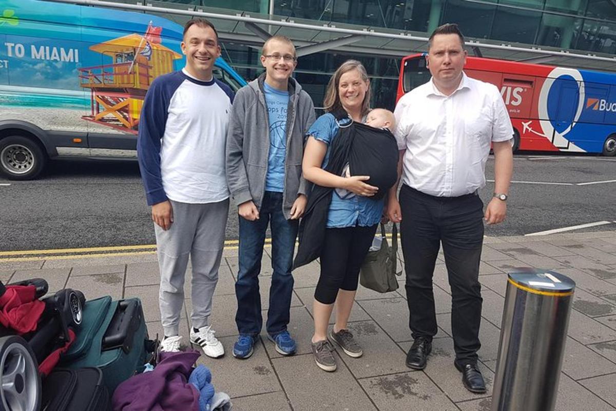 a group of people standing on a sidewalk with luggage