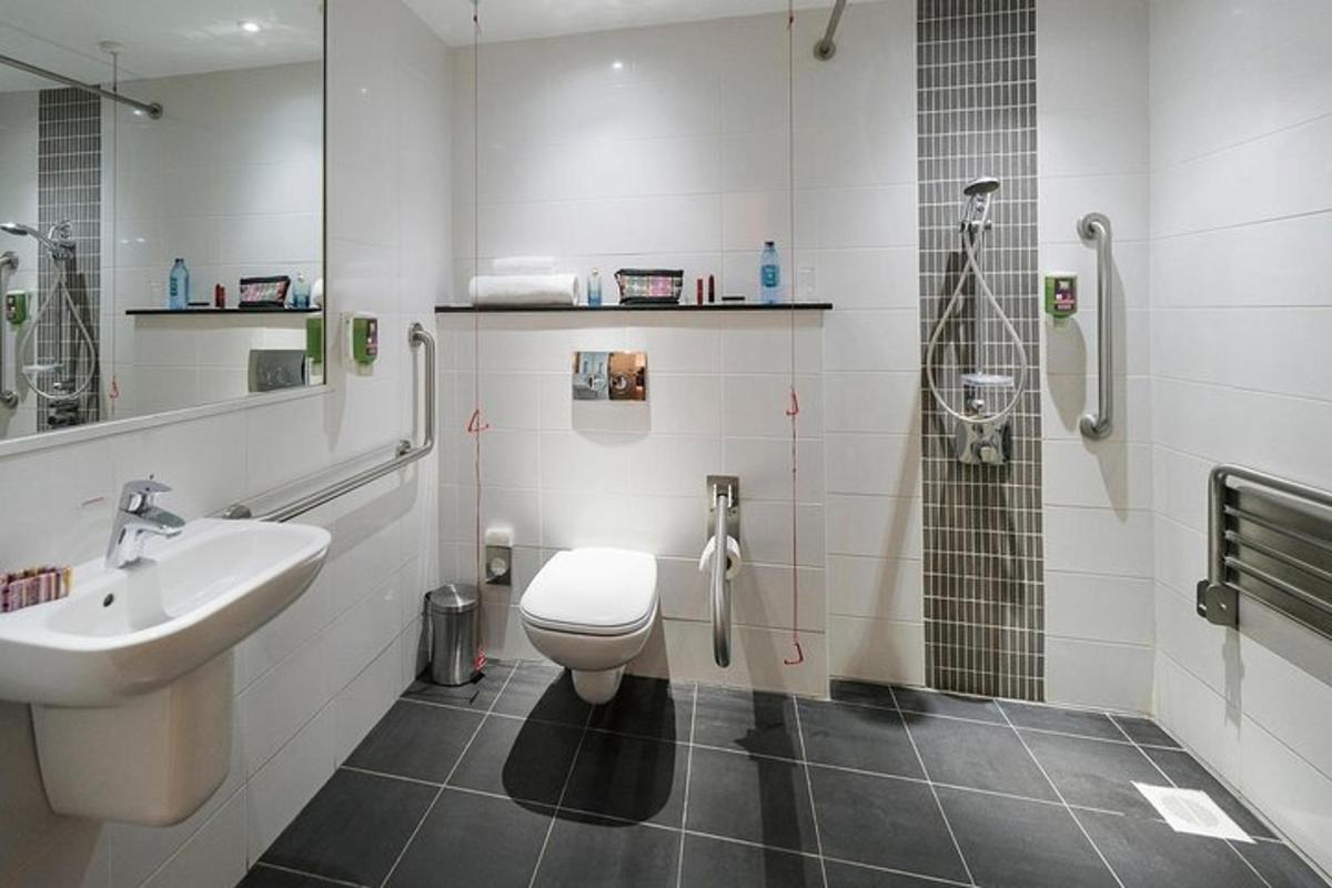 a bathroom with a toilet and a sink and a shower