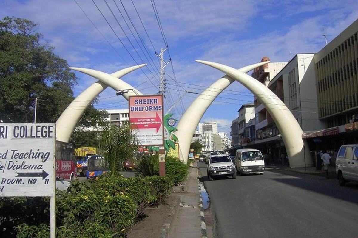a street with two large white archways in a city