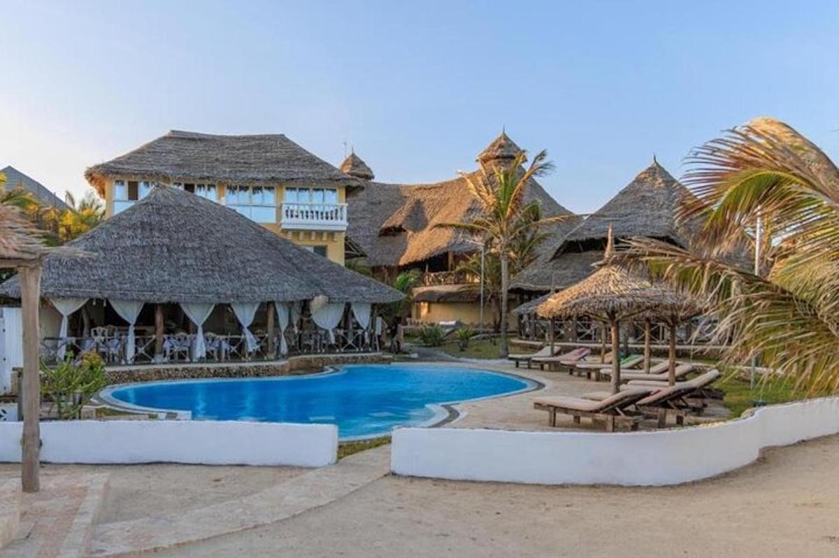resort s bazénem, lehátky a slunečníky