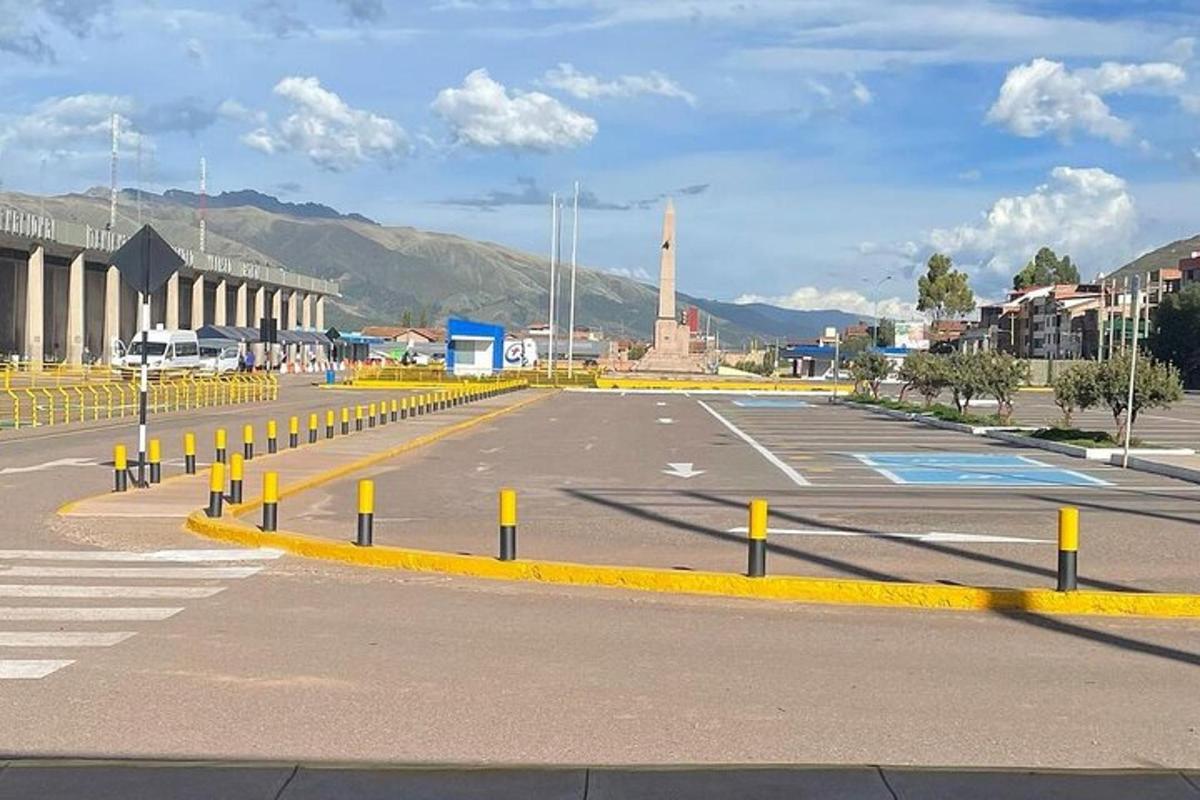 an empty parking lot with yellow barriers in a city