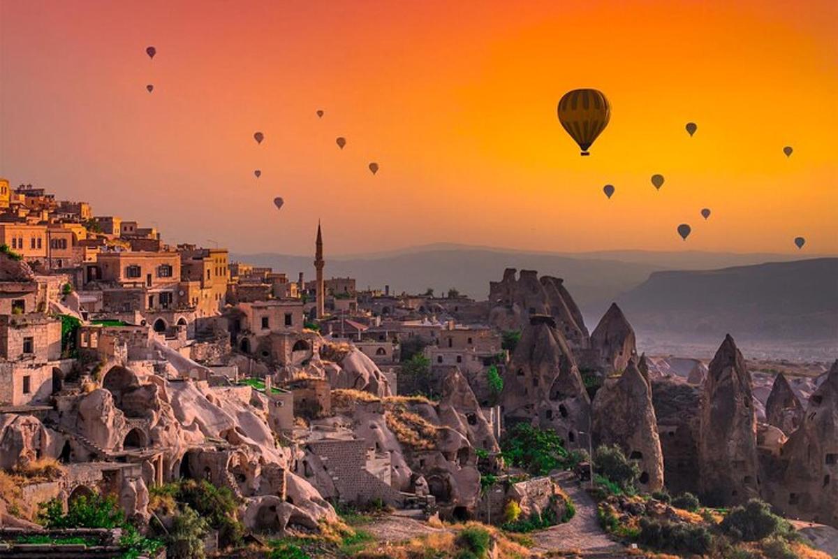 a group of hot air balloons flying over a city