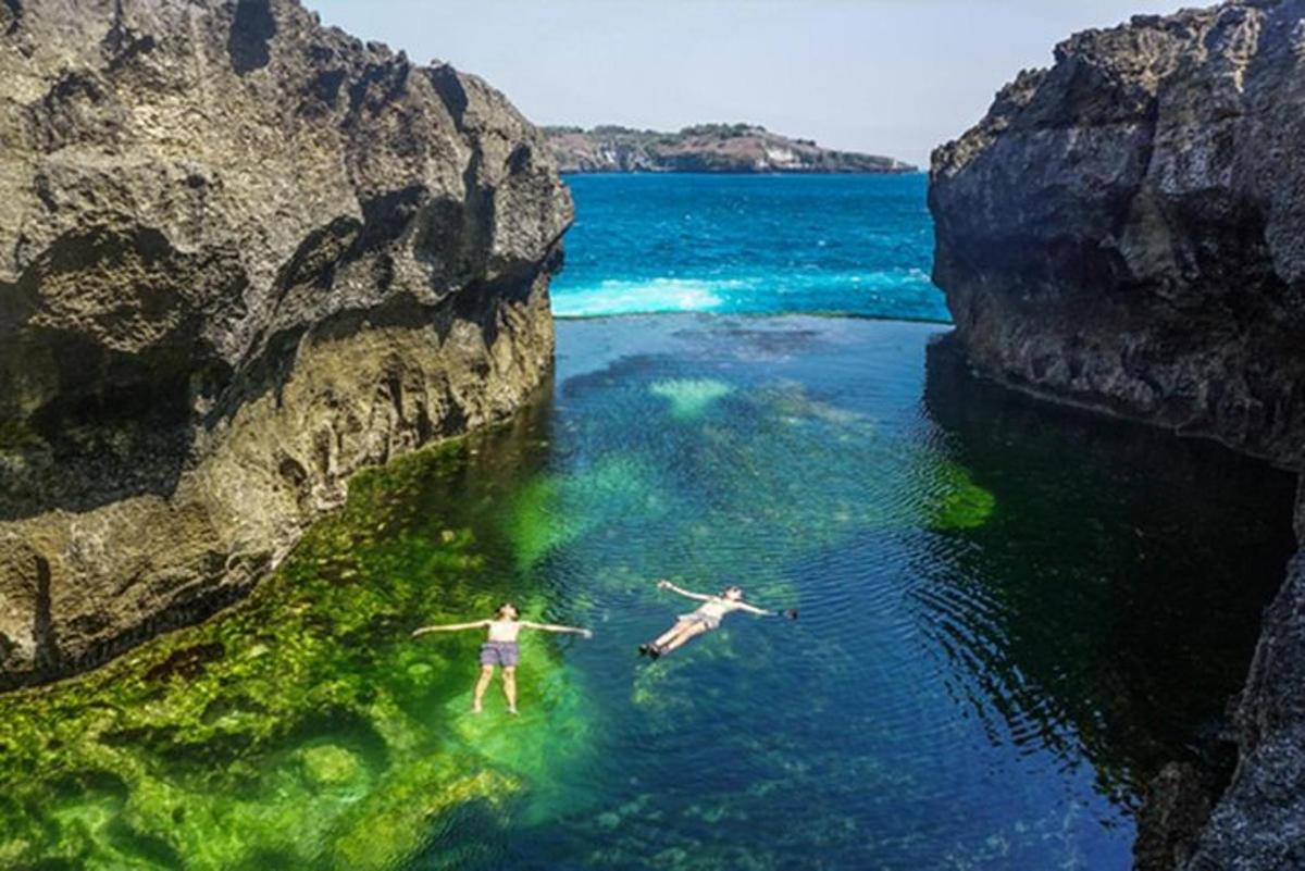 dues persones surant a l'aigua entre dues roques