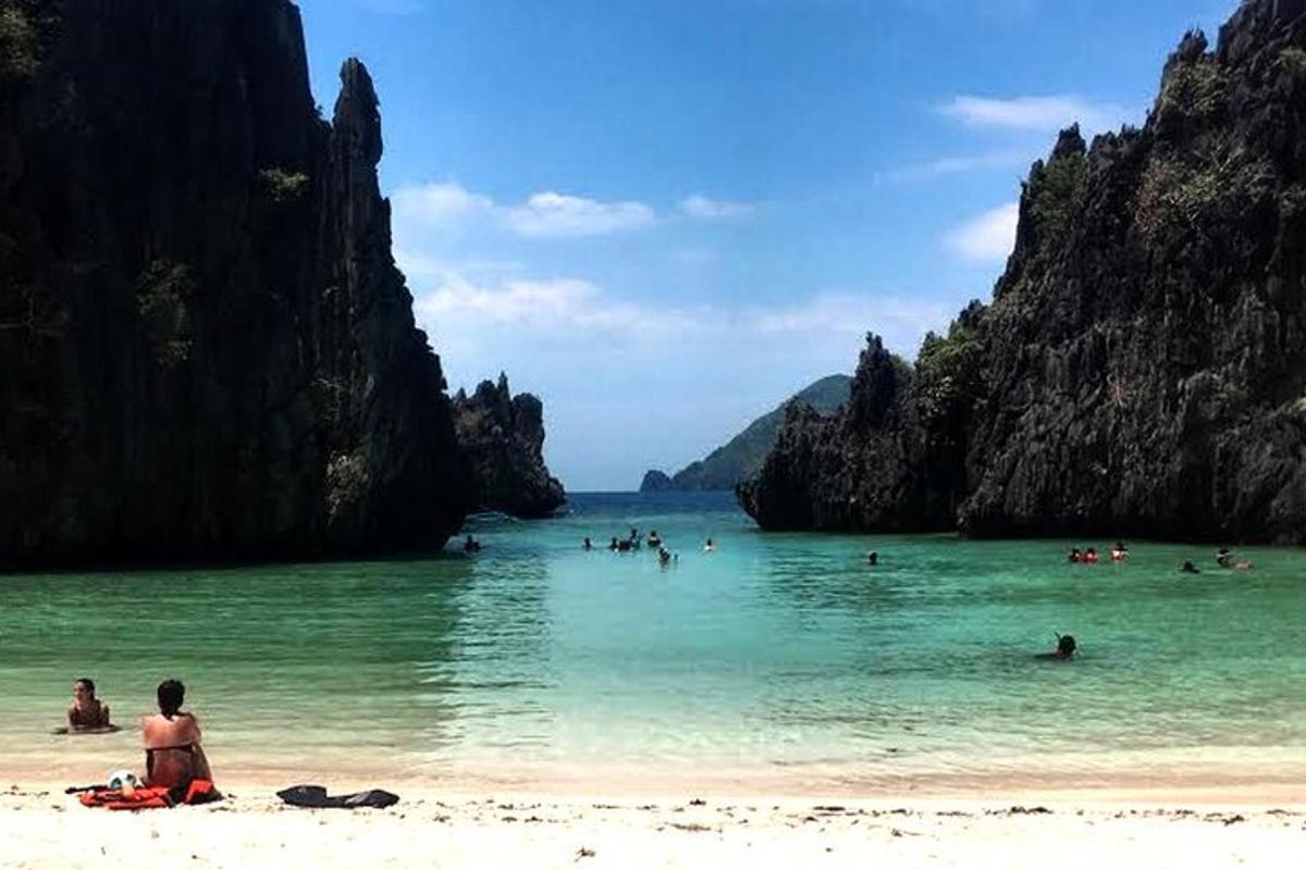 a group of people in the water at a beach