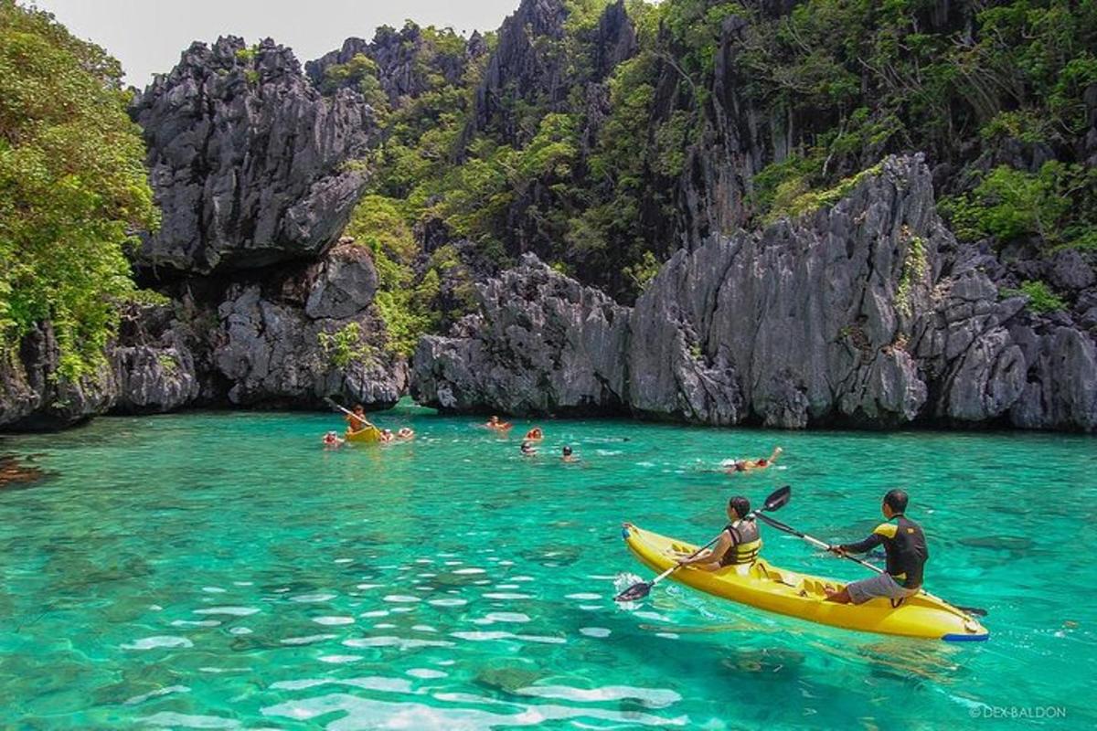 a group of people in a yellow kayak in the water