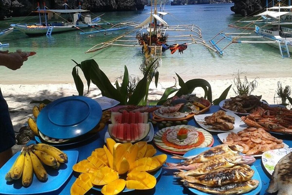 a table with food on a beach with the water
