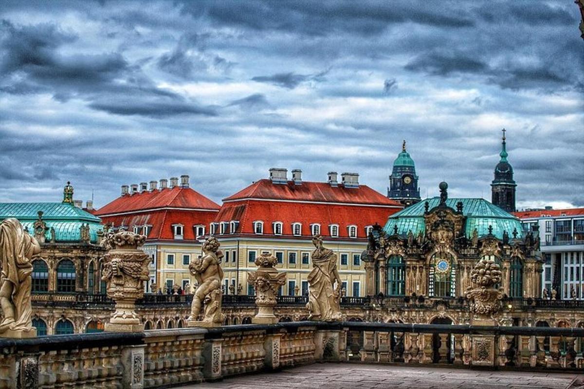 a large building with red roofs and a bridge
