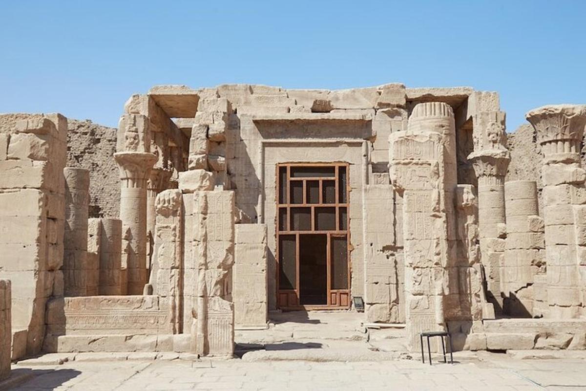 a large building with columns and a door in the middle