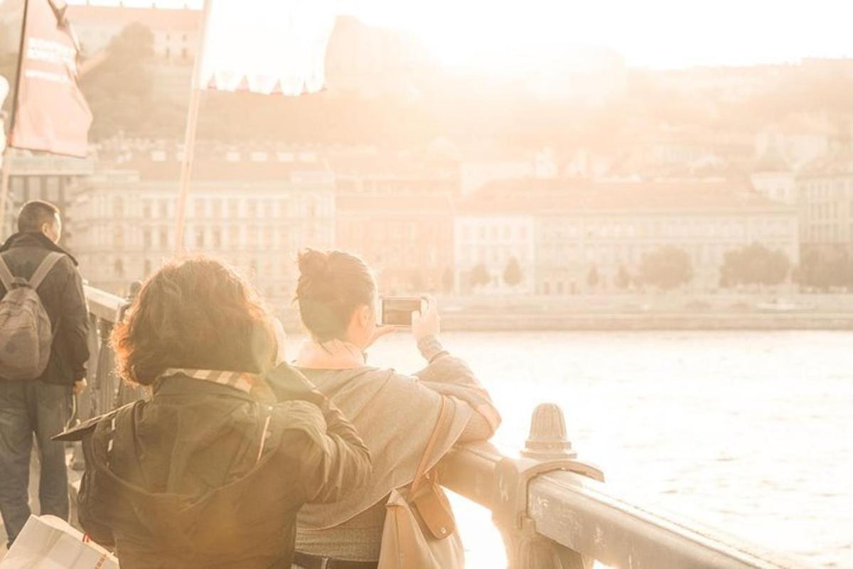 a couple of people taking a picture of the water
