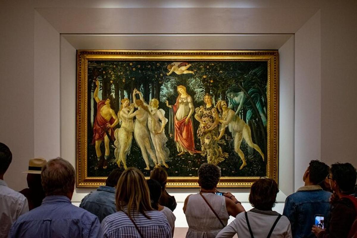 a group of people looking at a painting in a museum