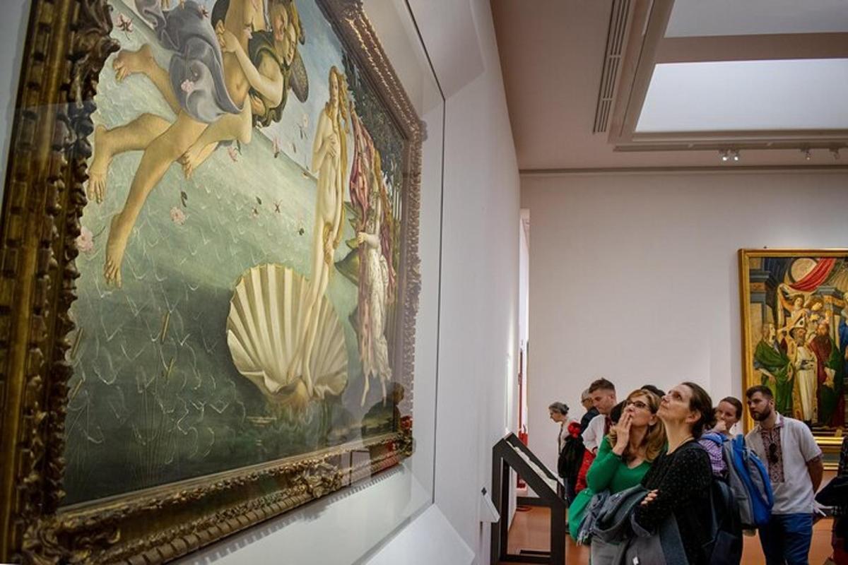 a group of people looking at a painting in a museum