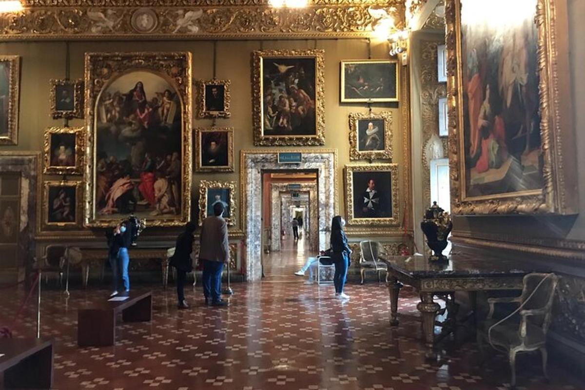 people standing in a room with paintings on the walls