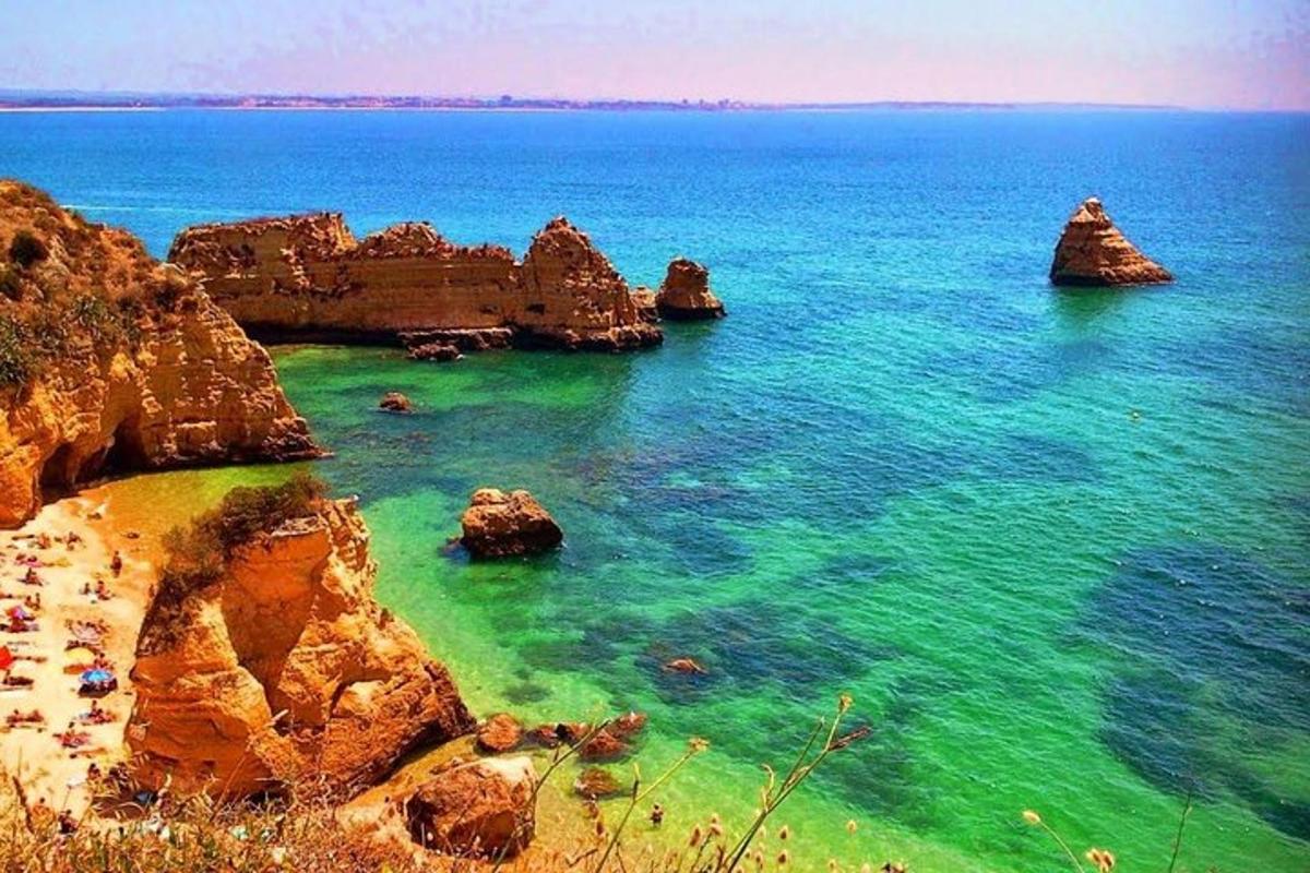 a view of a beach with rocks in the water